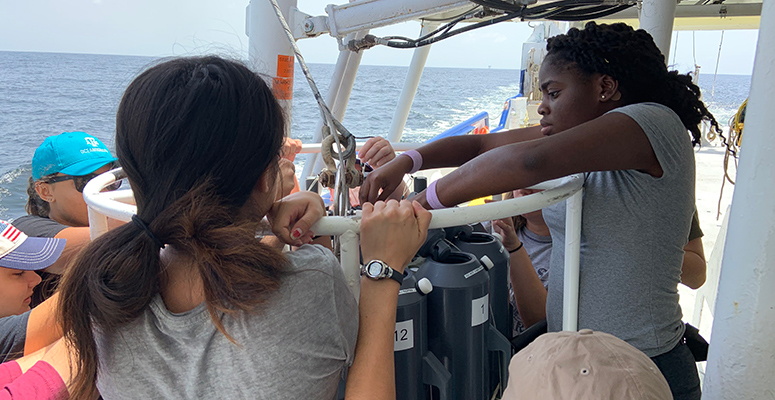 REU students working aboard a research vessel.