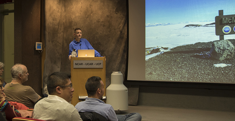 Man presenting research in an auditorium