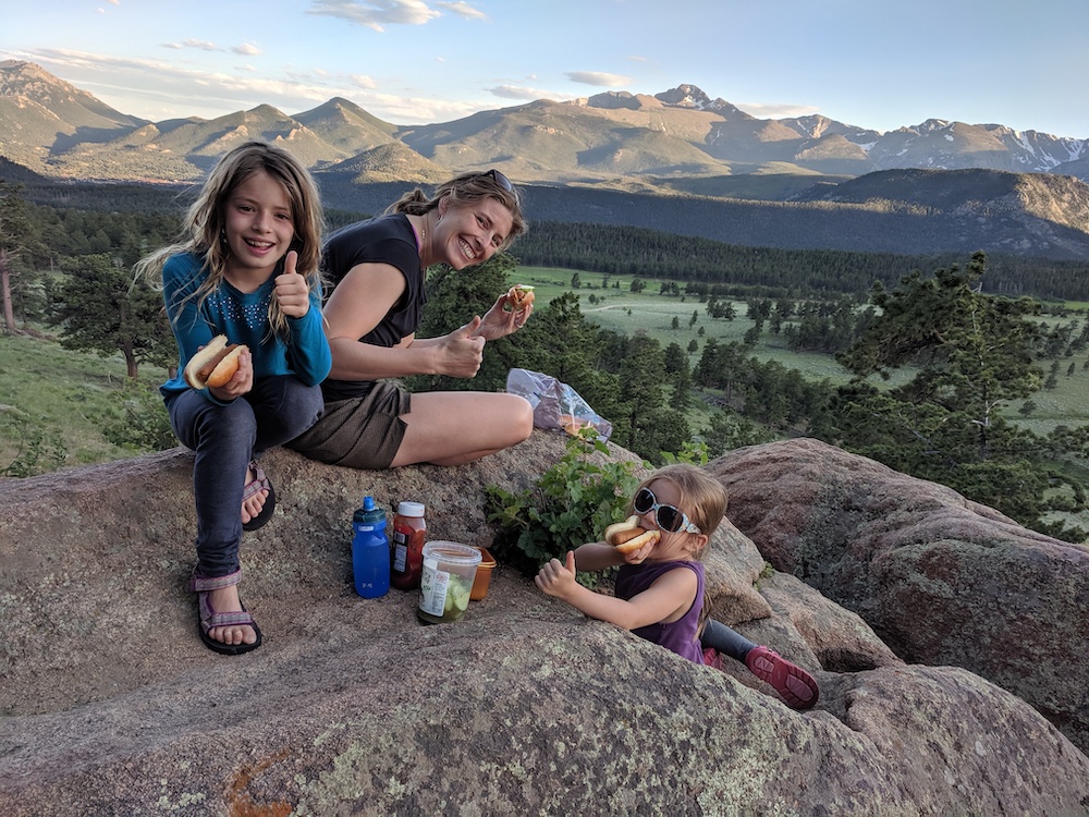 Dr. Fischer with her daughters enjoying a picnic lunch during a hike in the mountains