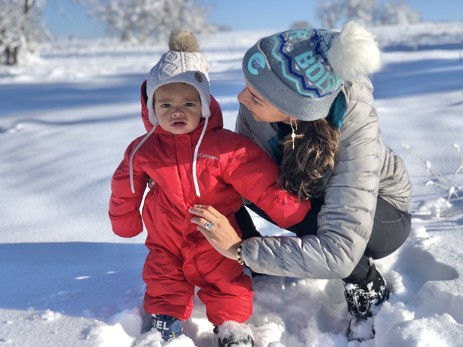 Dr. Rios-Berrios with her child in a field of snow.