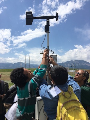 Students work to install a weather station