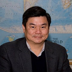 Image of Wen-Chau with an image of the world map in the background. 