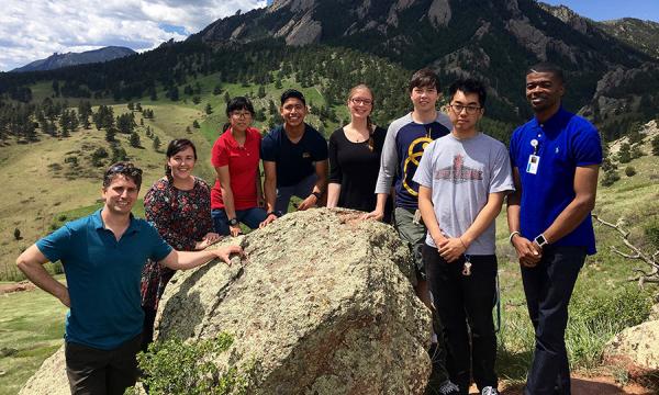 Group photo of interns in front of the Boulder Flatirons