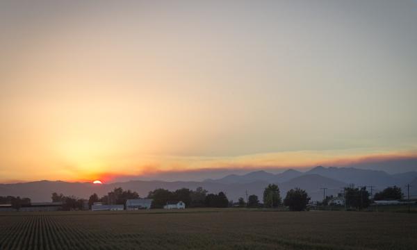 A sunset over a smoky horizon due to a wildfire