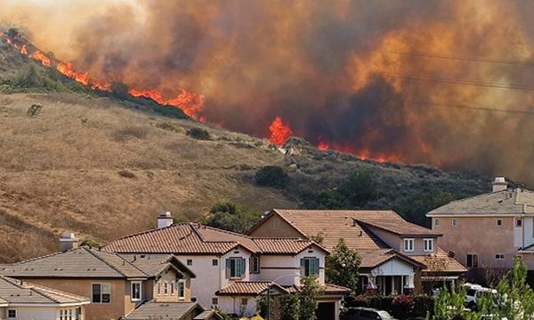 Image of fire burning behind a neighborhood by FEMA