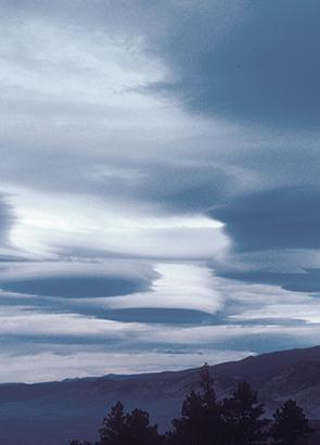 Lenticular, or lee wave, clouds form downwind from an obstacle in the path of a strong air current. In the Boulder, Colorado, area, the obstacle is the Front Range of the Rocky Mountains. Lenticular clouds can often be seen along the lee side of the range.
